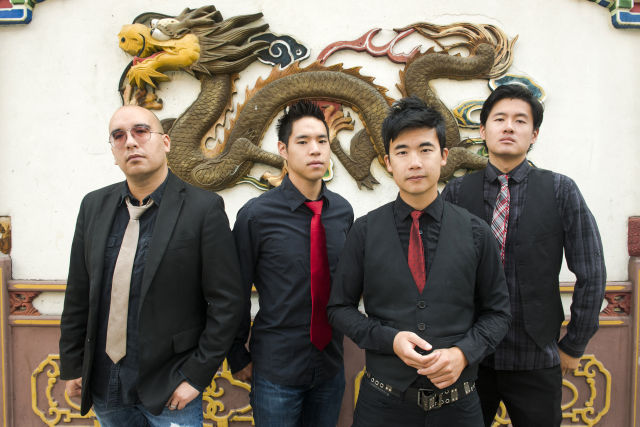 Portrait of Asian-American band The Slants (L-R: Joe X Jiang, Ken Shima, Tyler Chen, Simon "Young" Tam, Joe X Jiang) in Old Town Chinatown, Portland, Oregon, USA on 21st August 2015. (Photo by: Anthony Pidgeon/Redferns)